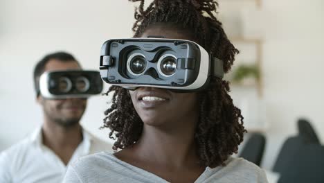 smiling african american woman wearing vr glasses