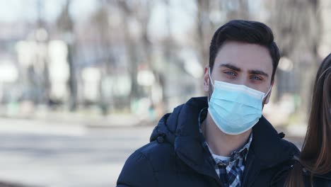 couple wearing masks outdoors