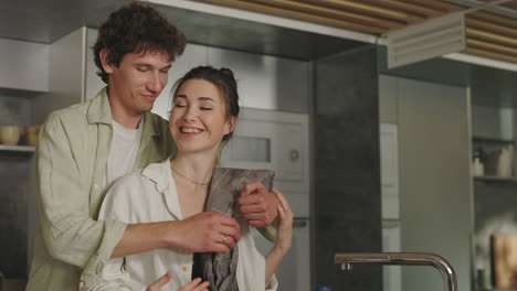 a loving couple shares intimate moments in their modern kitchen