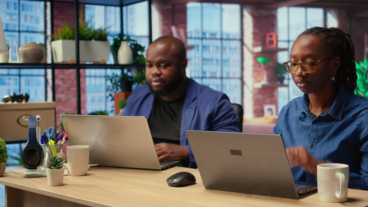 African American couple works from home collaborating on a freelance project