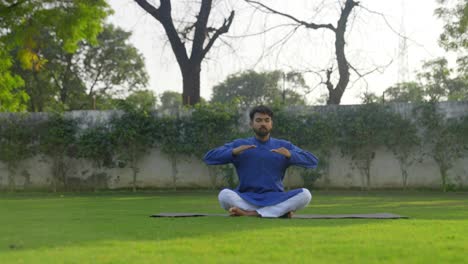 Indian-man-doing-breathe-in-breathe-out-yoga-exercise