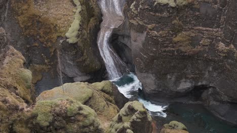 Stream-of-water-flowing-through-rocks-at-Fjadrargljufur-Canyon,-Iceland