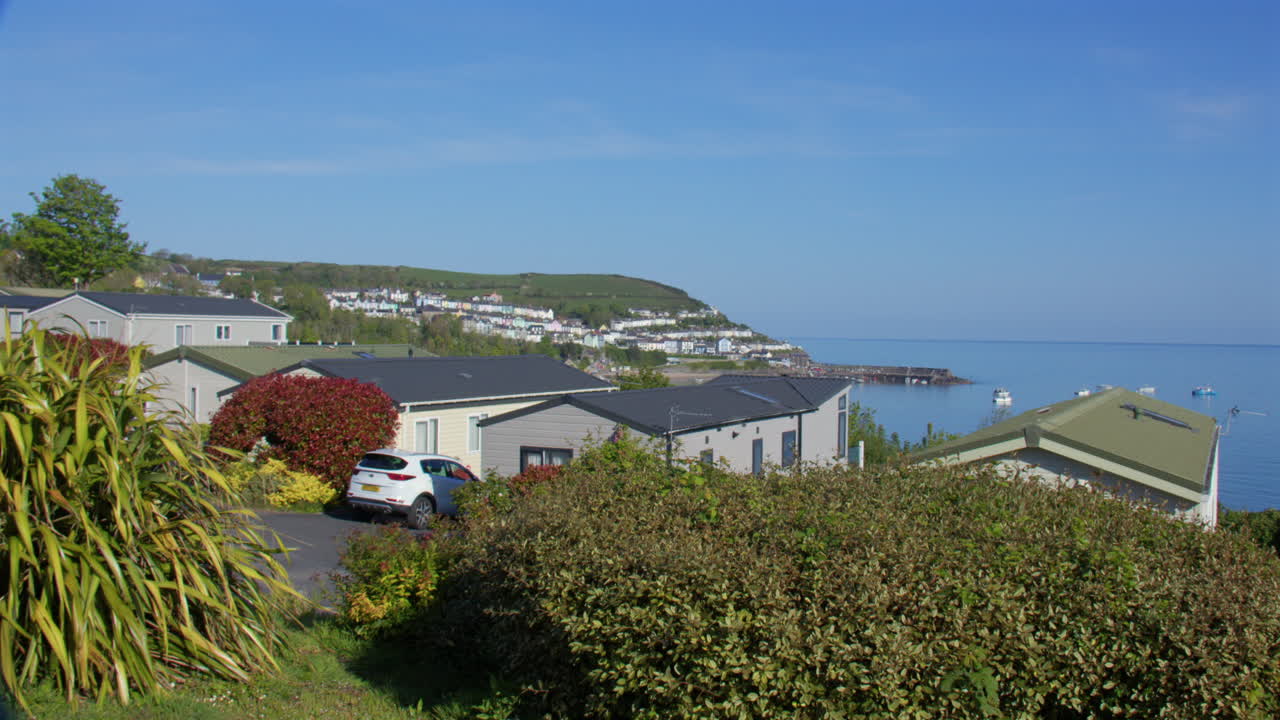 View over static caravans with New Quay in background at Cardigan Bay