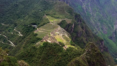 aerial drone pan of machu picchu at huayna pichu mountain peak, peru