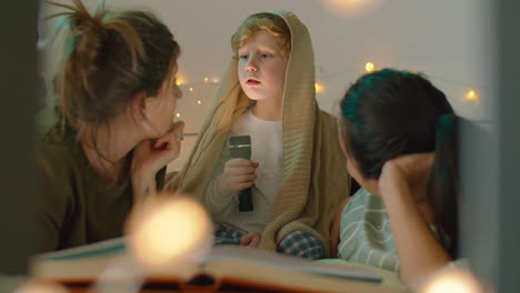 lesbian couple listening to bedtime story from little son