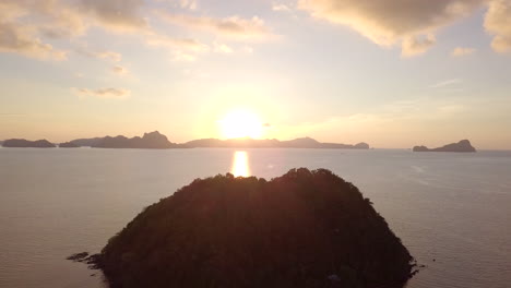 beautiful sunset reflecting the ocean in tropical island of philippines, el nido, palawan with silhouette limestone cliffs on background