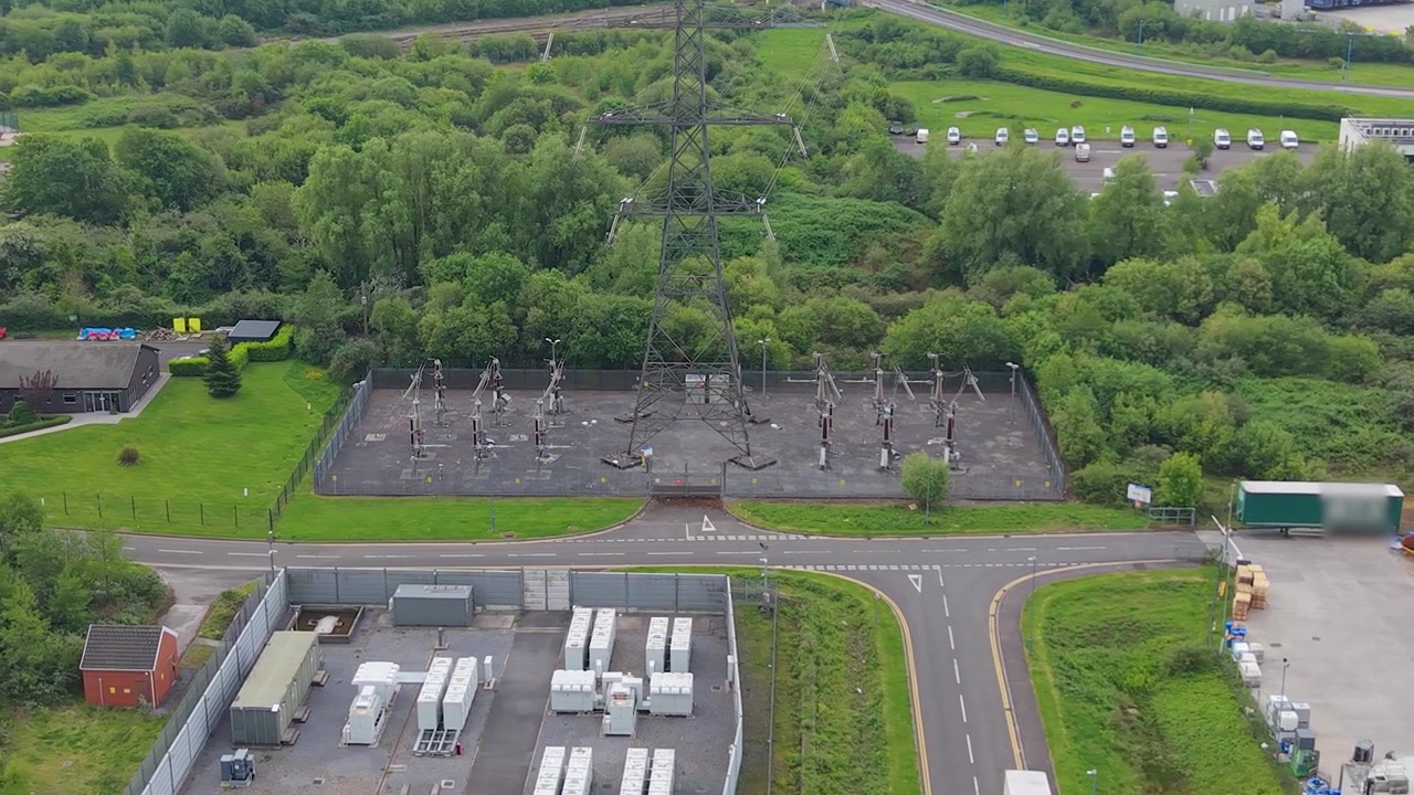 Electrical Substation with nearby BESS Battery Storage System Containers nearby. Modern engineering, cutting-edge data and energy management in UK.