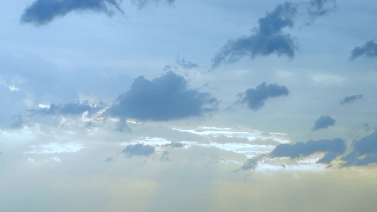 Soft blue clouds drifting in seamless looping background