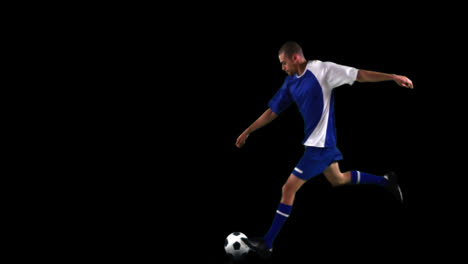 athlete practicing soccer against black background