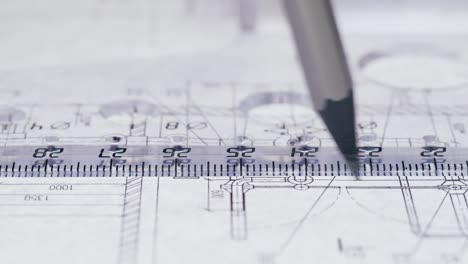close-up of a ruler and pencil on architectural blueprints
