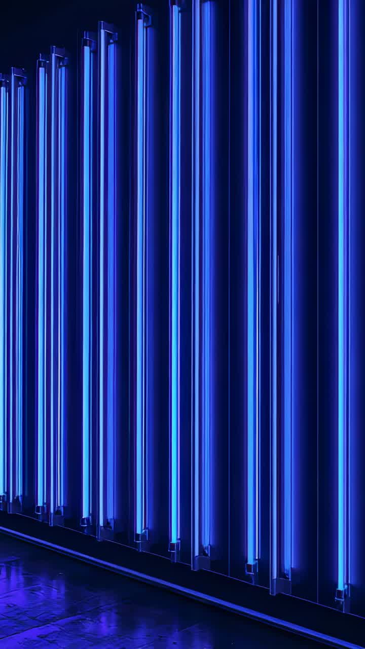 Vertical video: Glowing blue tubes powered, casting reflections on gallery floor, creating rhythm