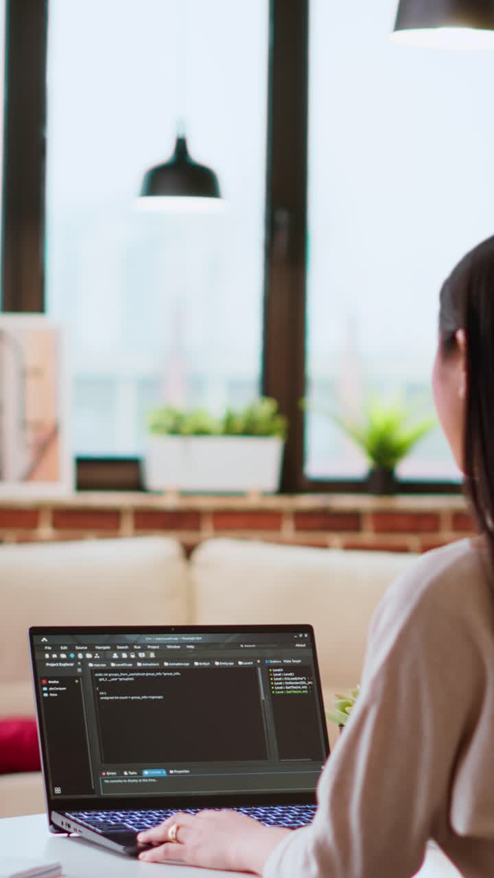 Vídeo vertical de un equipo creativo interracial programando código en un portátil y depurando
