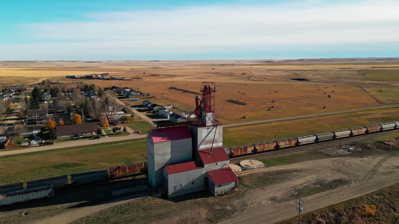 Panoramic drone fly around a grain elevator in rural prairie landscape, Saskatchewan Province, Francis, Canada agribusiness