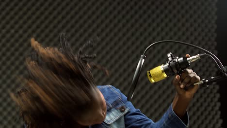 African-american-alfro-hair-black-Woman-sing-a-song-loudly-and-express-feeling-with-power-sound-over-hanging-microphone-condenser