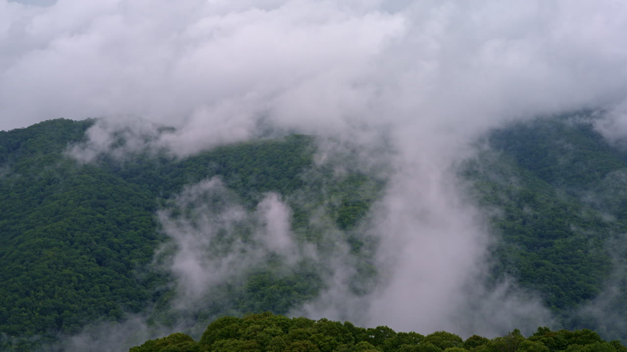 Moody drone shot of the Smokies wrapped in fog and mist