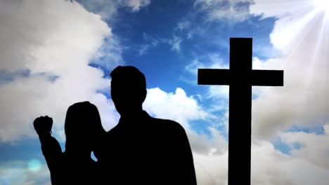 animation of silhouette of couple over clouds and cross