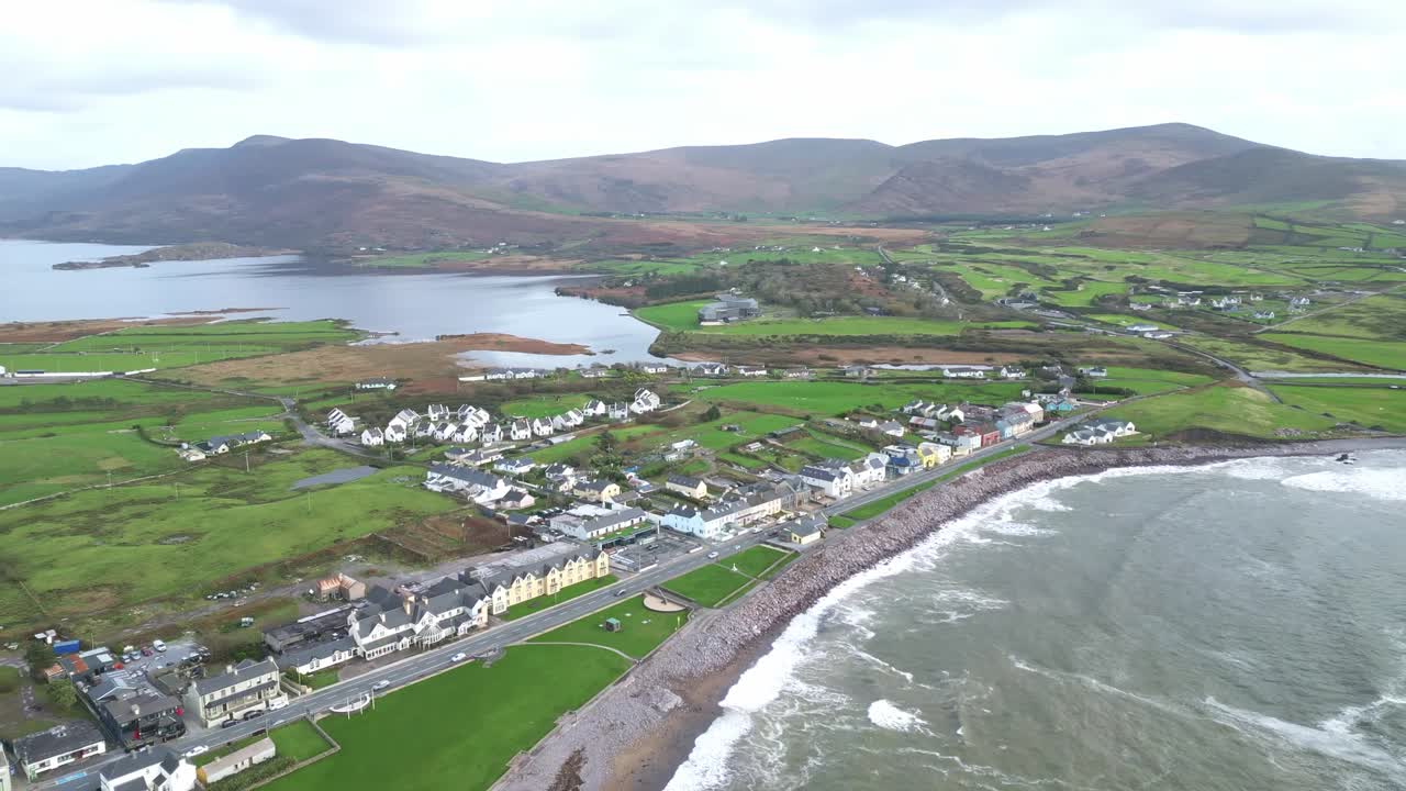 Drone footage over Waterville village in County Kerry, Ireland, revealing Lough Currane, coastal homes, and rolling hills along the scenic Iveragh Peninsula