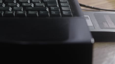Computer user inserts outdated floppy disc data storage into laptop CLOSE-UP