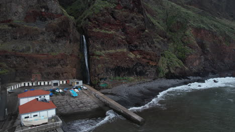 cinematic aerial shot over the paul do mar waterfall in the city of the same name