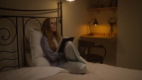 woman reading in bed at night