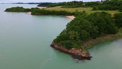 calm waters of arguenon river estuary, brittany coast, france. aerial drone backward