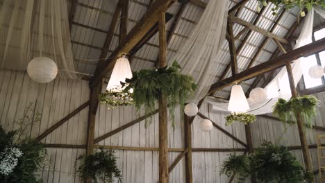 Boho-wedding-wooden-venue-with-stunning-lighters-and-plants