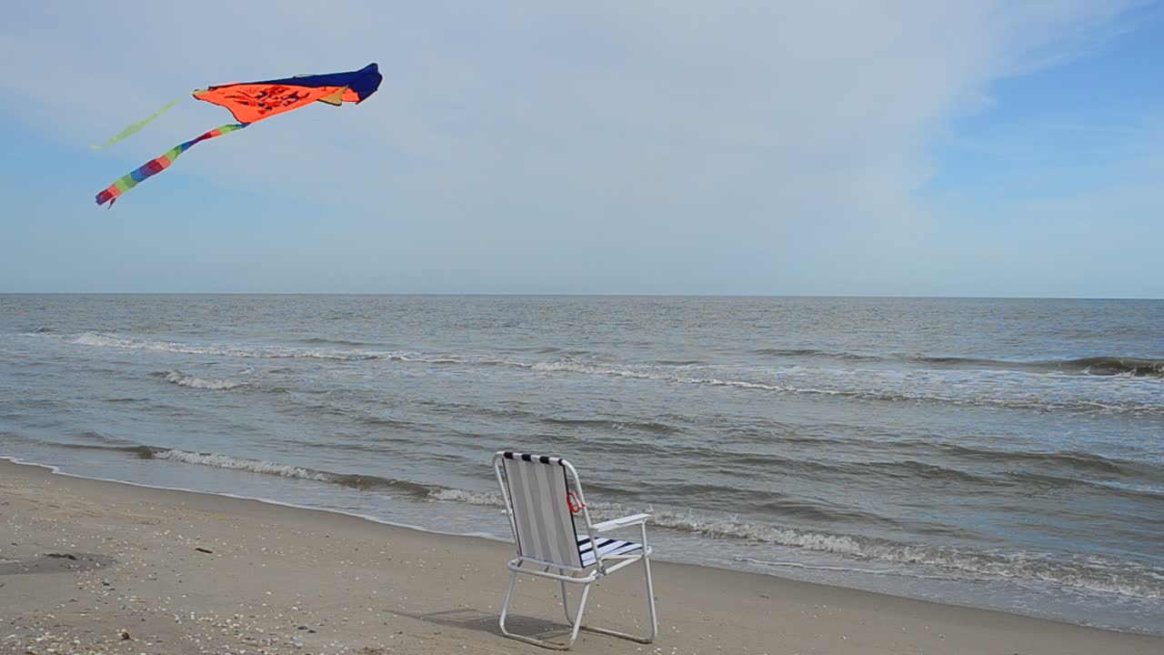 Chaise lounge on the beach, the sea and a kite. Summer Time in Beach Sea Shore