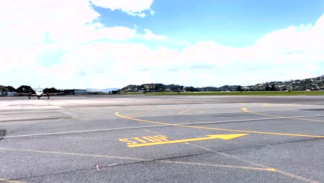 distant view of an airplane moving on the runway of an airport on a sunny day