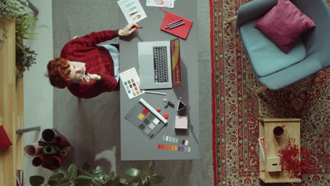 female designer talking on phone at workplace