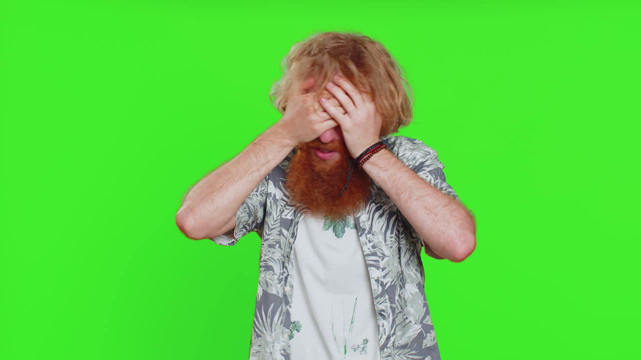 Afraid shocked young man closing eyes, confused shy scared reject to watch, phobia, shame, stress