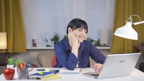 female student chatting with beloved on laptop.