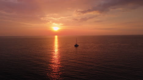 sunset over the ocean with a yacht