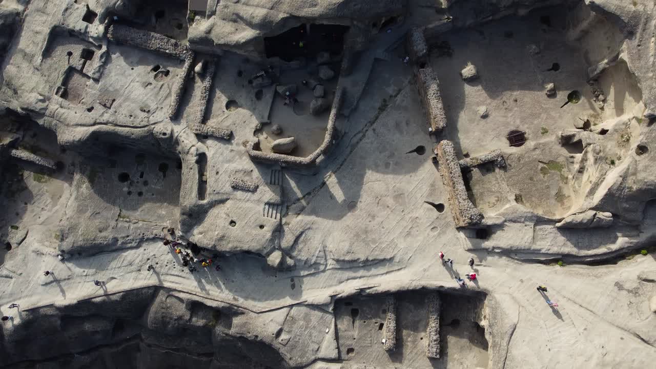 Aerial orbit of Uplistsikhe cave complex in Georgia showing ancient architecture in rock