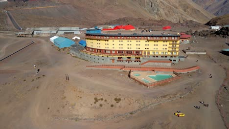aerial view dolly in of the portillo hotel in los andes, chile on a sunny day