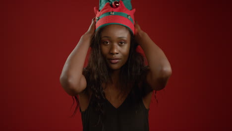 Young-Woman-Puts-Christmas-Elf-Hat-On