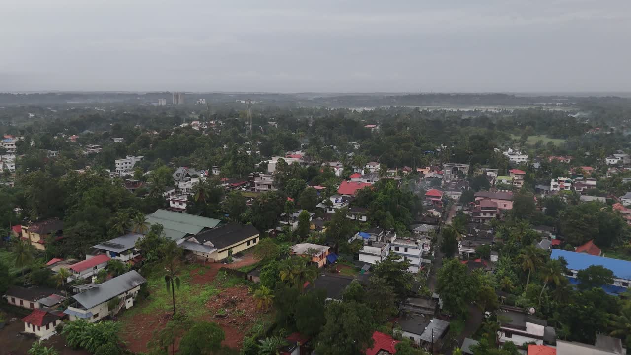 Drone shot of Kottayam town with lush greenery and scattered houses
