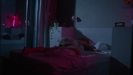 woman sleeping in a nighttime bedroom