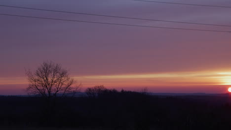 medium shot of an electricity pylon at sunrise