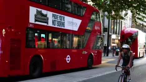 red bus and cyclists on london street