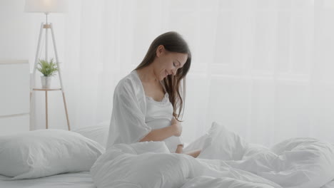 pregnant woman relaxing in bed