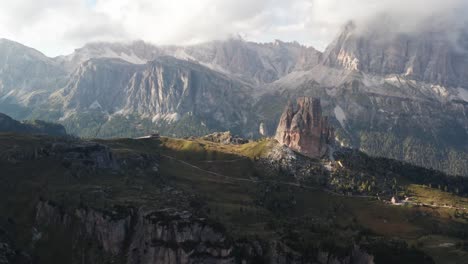 aerial tilt up of cinque torri towers in sunlight, tofane range in background