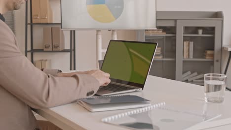 cropped manager typing on computer keyboard