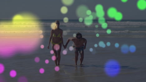 walking on beach, couple surrounded by colorful bokeh animation overlay
