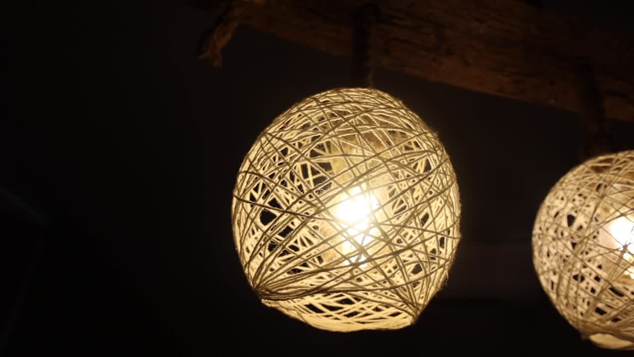 Detail close up of rattan wicker indoor lights, hipster lamps illuminating