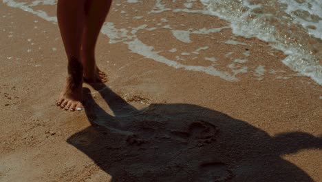 woman's feet in the ocean waves