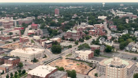 an aerial view of the st. joseph church in macon, georgia, with construction sites in the foreground. the church is a preserved neo-gothic masterpiece in a modernizing southern city