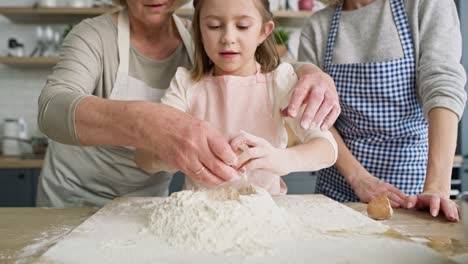 video of little girl breaks an egg into the flour