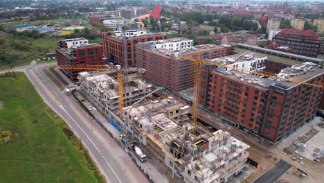 construction site of modern buildings with tower cranes and heavy equipment in gdansk centre, poland