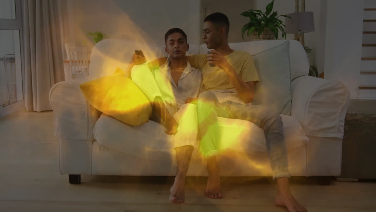 Couple relaxing on couch with warm light animation over them
