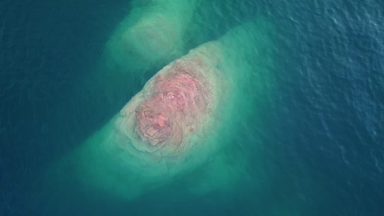 Abstract Aerial View of Red Rock Islet in Turquoise Water of Lake. Sand Hollow State Park, Utah USA